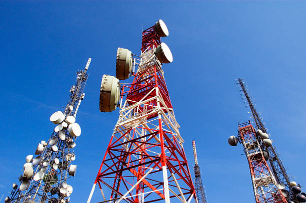 telecommunications tower, blu skye with clouds - zendmast stockfoto's en -beelden