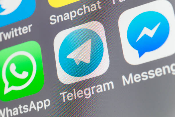 Telegram, Messenger, Whatsapp and other cellphone Apps on iPhone screen stock photo