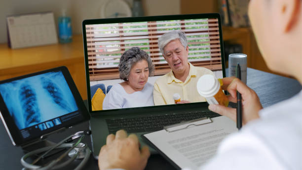 Telehealth concept,doctor video call with couple senior about prescription on digital tablet while staying at home,telemed concept stock photo