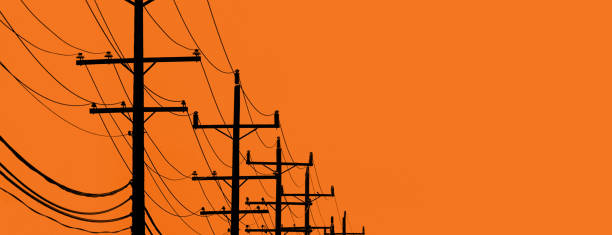 Telephone poles and wires Telephone poles and wires in the distance with and orange background telephone pole photos stock pictures, royalty-free photos & images