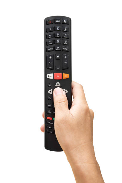 Television remote control in hand and press on white background stock photo