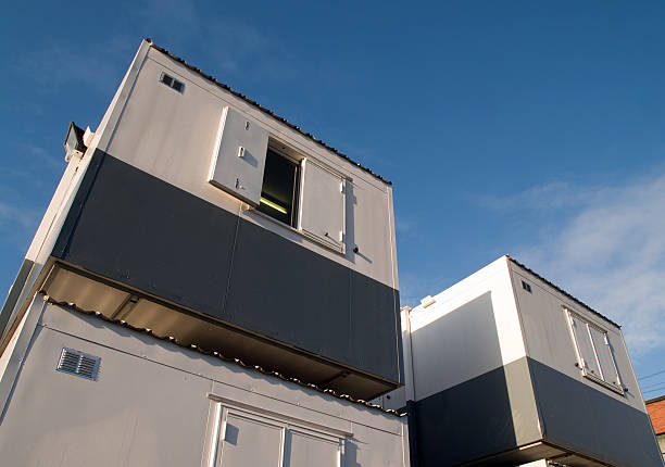 Temporary office stack of portable cabins on construction site. stock photo