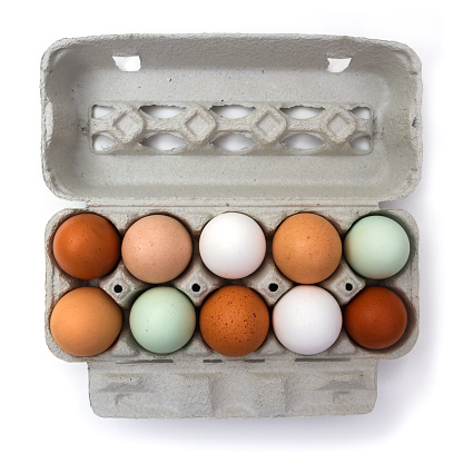 Ten colorful chicken eggs in carton box, isolated on white