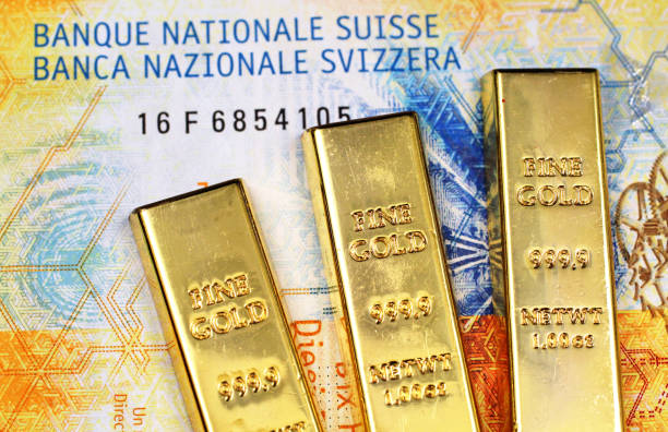 Ten Swiss Franc bank note with three gold bars stock photo