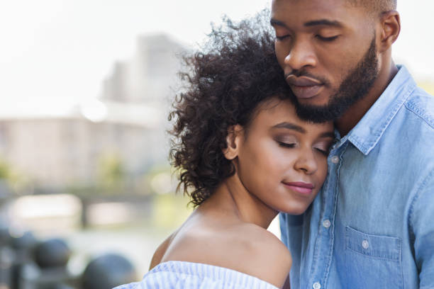 Tender black couple hugging with closed eyes Tender black couple hugging with closed eyes outdoors falling in love stock pictures, royalty-free photos & images