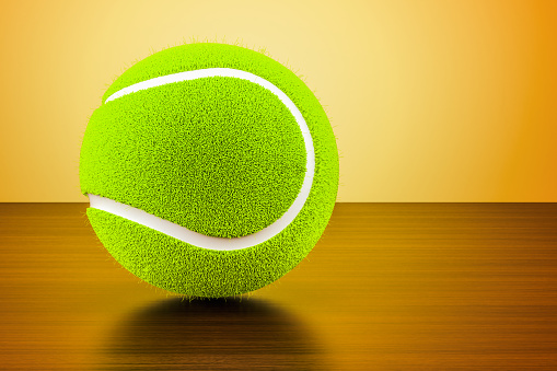 Office workplace with a blank sheet, pen, stamp, soccer and tennis balls, trophies on a blurred background. Sports business concept. Management, negotiations, contracts. Copy space. Selective focus.