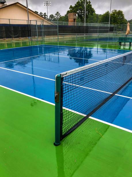 Tennis Court Tennis Court Covered in Rain on a Summer Morning michael dean shelton stock pictures, royalty-free photos & images