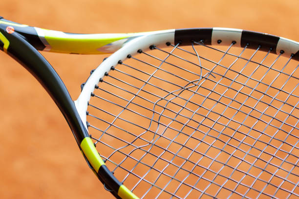 Tennis racket with broken strings. stock photo