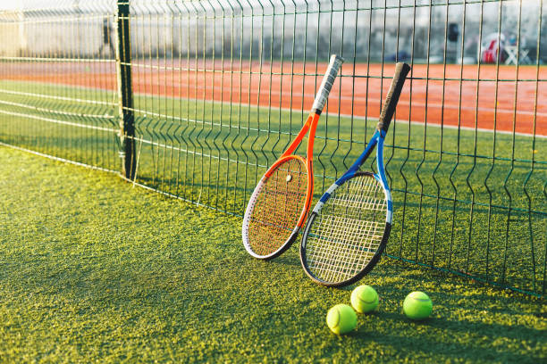 Tennis rackets on grass stock photo