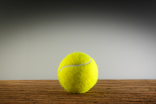 Tennis ball on the wooden table. 3D rendering