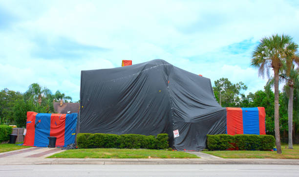 Tented large two story house that is being treated to kill termites and other bugs with structural fumigation stock photo