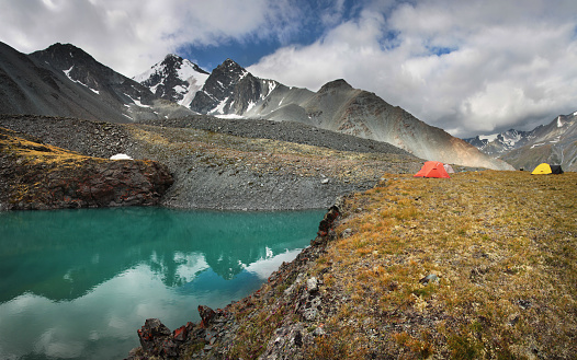 Tents on the shore of a mountain lake, trekking and travel