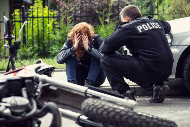 Terrified victim of a traffic collision of motorcycle with a car and policeman  victim stock pictures, royalty-free photos & images