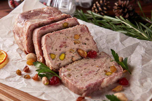 Terrine of ground meat, ham, raisins, pistachios Christmas terrine of ground chicken meat, ham, raisins and pistachios casserole dish stock pictures, royalty-free photos & images