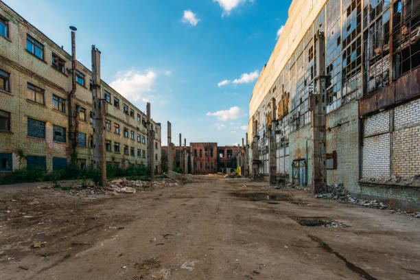 Territory of abandoned industrial area waiting for demolition. Broken and burnt buildings. Former Voronezh excavator factory stock photo