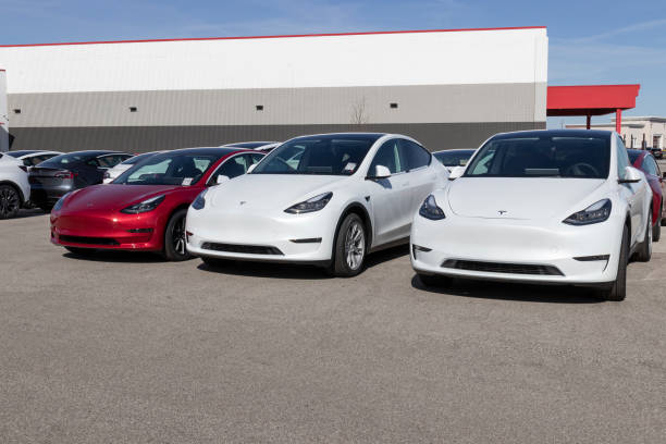 Tesla electric vehicles awaiting preparation for sale. Tesla products include electric cars, battery energy storage and solar panels. stock photo
