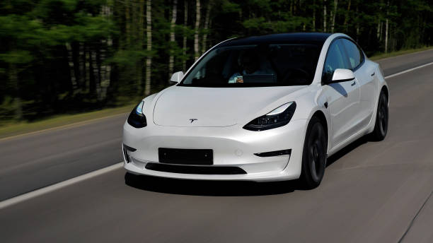 2021 Tesla Model 3 Performance. No license plate. Minsk, Belarus - April 15, 2021: Tesla Model 3 Performance 2021 MY drives on a highway. It has dual-motor all-wheel drive, total output is 451 hp. Model 3 is the best-selling plug-in electric vehicle. tesla motors stock pictures, royalty-free photos & images