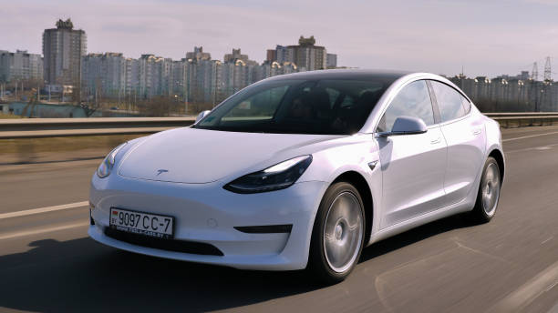 Tesla Model 3 Performance Minsk, Belarus - March 20, 2020: Tesla Model 3 Performance drives on a highway. It has dual motor all-wheel drive, total output is 451 hp. Model 3 is the world's best-selling plug-in electric vehicle. tesla motors stock pictures, royalty-free photos & images