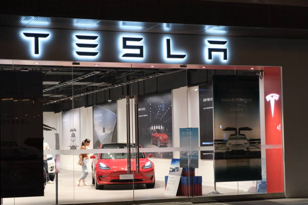 Tesla store with customers inside at night in Asia Shanghai/China