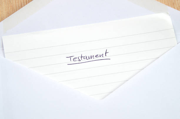 Testament, handwritten letter in white envelope, wooden background stock photo