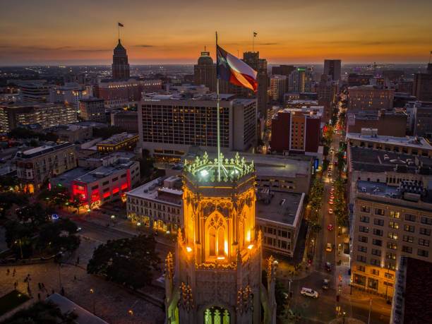 Texas Flag in San Antonio, Texas Aerial photo taken over a building with a Texas Flag in downtown San Antonio, Texas during sunset. san antonio stock pictures, royalty-free photos & images