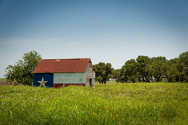 Texas Proud Barn Rustic barn with a Texas flag pained on the side texas stock pictures, royalty-free photos & images