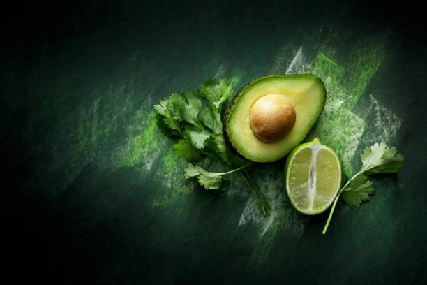 TexMex Food: Ingredients for Guacamole Still Life  guacamole lime stock pictures, royalty-free photos & images, avocado pits keep guacamole fresh