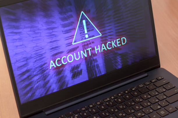 Text account hacked on laptop screen. Warning triangular sign with exclamation mark symbol. Blue screen. Horizontal. Text account hacked on laptop screen. Warning triangular sign with exclamation mark symbol. Blue screen. Horizontal. computer crime stock pictures, royalty-free photos & images