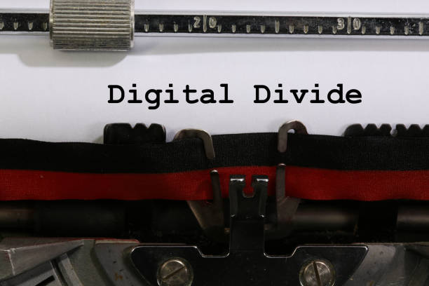 Text Digital Divide written with the old typewriter stock photo