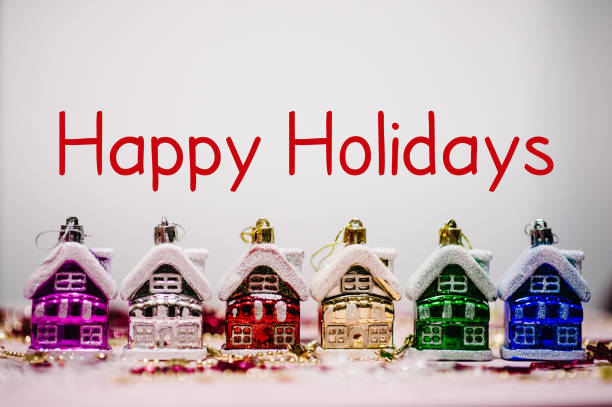 Text happy holidays. Merry Christmas concept. Christmas tree decorations in form of colored europe houses, snowflakes. New Year city banners, card. blurred. Festive background, Happy New Year 2018. stock photo