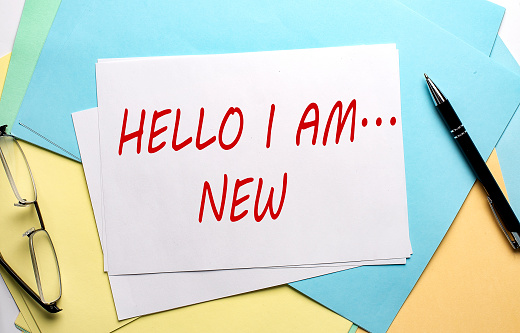 HELLO I AM ...NEW text on the paper on the colorful paper background