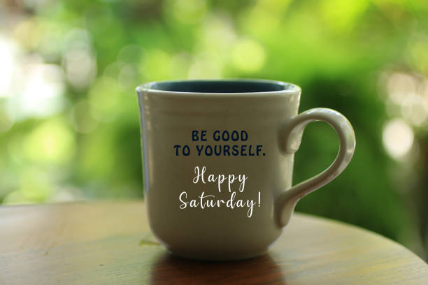 Text on white morning coffee cup - Be good to yourself. Happy Saturday. Inspirational quote - Be good to yourself. Happy Saturday concept. With inspiration words on a white cup of hot morning tea or coffee. Blurred green bokeh background. sunday morning coffee stock pictures, royalty-free photos & images