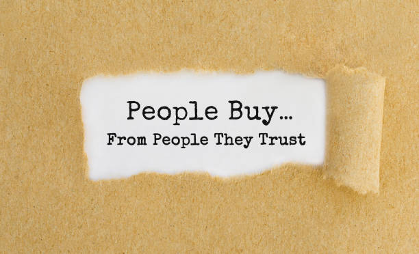 Text People Buy From People They Trust appearing behind ripped brown paper.  buy single word stock pictures, royalty-free photos & images