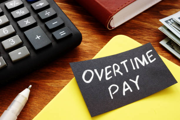 Text sign showing hand written words Overtime pay stock photo