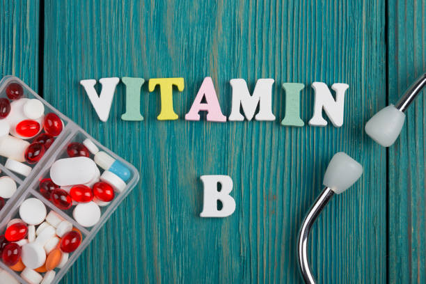 Text "Vitamin B" of colored wooden letters, stethoscope and pills stock photo