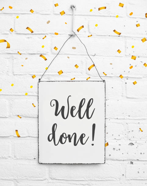 Text well done congratulations on white metal plate with confetti stock photo
