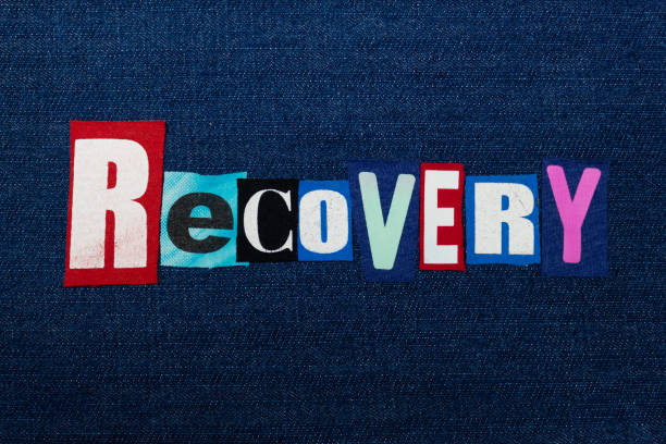 RECOVERY text word collage, colorful fabric on blue denim, abuse and treatment concept RECOVERY text word collage, colorful fabric on blue denim, abuse and treatment concept, horizontal aspect drug rehab stock pictures, royalty-free photos & images