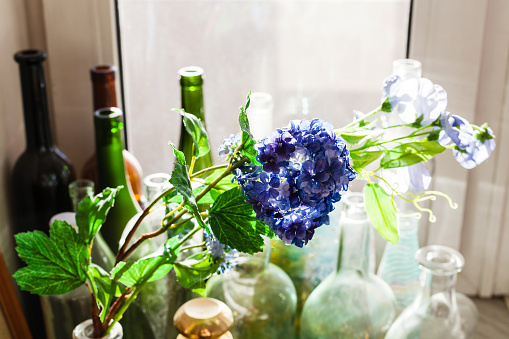 textile artificial flower and old bottles
