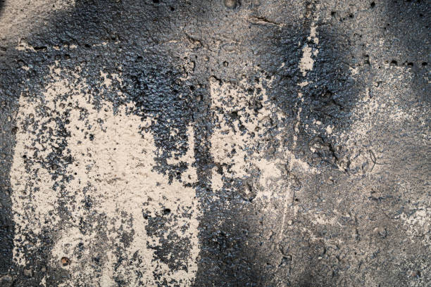 Texture of an old concrete wall with traces of soot. Dark background stock photo