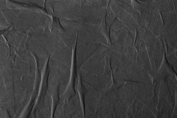 Texture of black paper with folds. stock photo