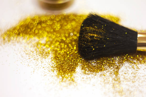 texture of gold glitter on the makeup brush and design. On white background. Selective Focus - Image stock photo