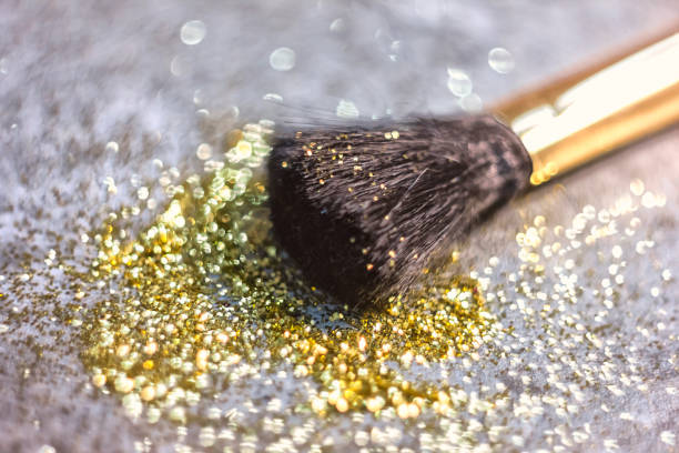 texture of gold glitter on the makeup brush and design stock photo