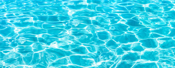 Texture of the water surface. Shining blue water ripple background. Surface of water in swimming pool. Tropical beach water background. standing water stock pictures, royalty-free photos & images