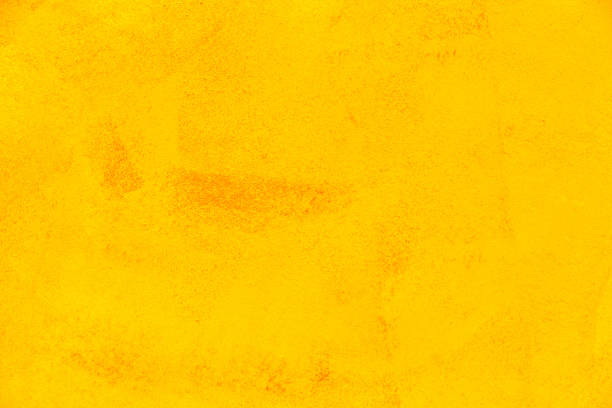 Texture of yellow plaster cement wall stock photo