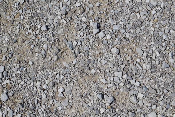 Textures of Gravel Pebbles and Stones A close up view of the textures and pattern of the pebbles and stone in the gravel surface. gravel stock pictures, royalty-free photos & images