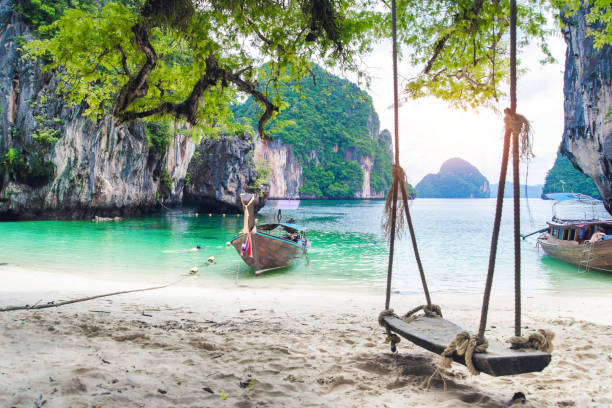 Thai traditional wooden longtail boat and beautiful sand Railay Beach in Krabi province. Hong Island, Thailand. stock photo