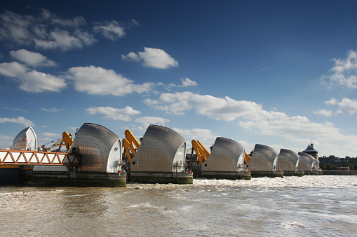 The Thames flood barrier with blue sky and white clouds