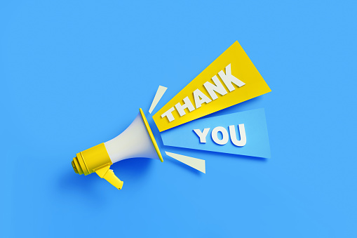 Thank you coming out from a yellow megaphone on blue background. Horizontal composition with copy space. Great use for thank you and gratitude concepts.