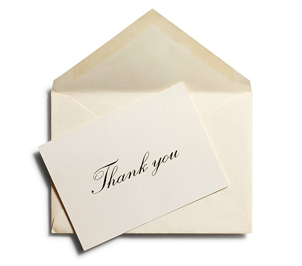 Thank you note against an open envelope isolated stock photo