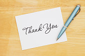 istock Thank you note with a pen on a desk 1370942141